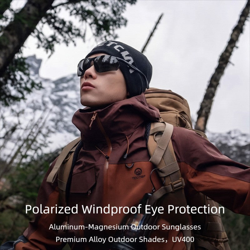 Male model wearing AvilaDubee AD8803 alloy sport polarized sunglasses with backpack in mountain forest, windproof UV400 glare protection for long ride hiking fishing outdoor lifestyle shot