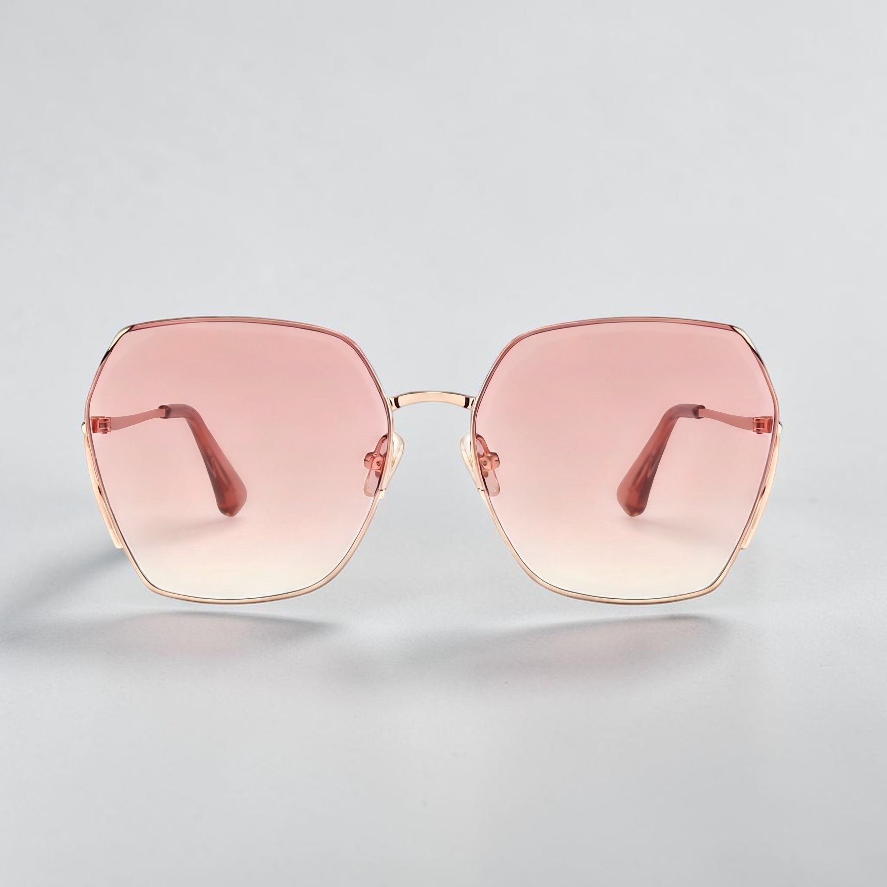 Minimalist white background studio shot of AvilaDubee DB7258 oversized square sunglasses, rose gold alloy frame blush pink gradient UV400 nylon lenses luxury women’s daily driving shades