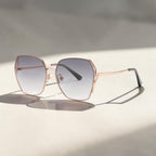 Soft sunlight shadow photo of AvilaDubee DB7258 rose gold oversized square sunglasses, mist grey gradient nylon UV400 lenses minimalist luxury fashion eyewear for beach trips