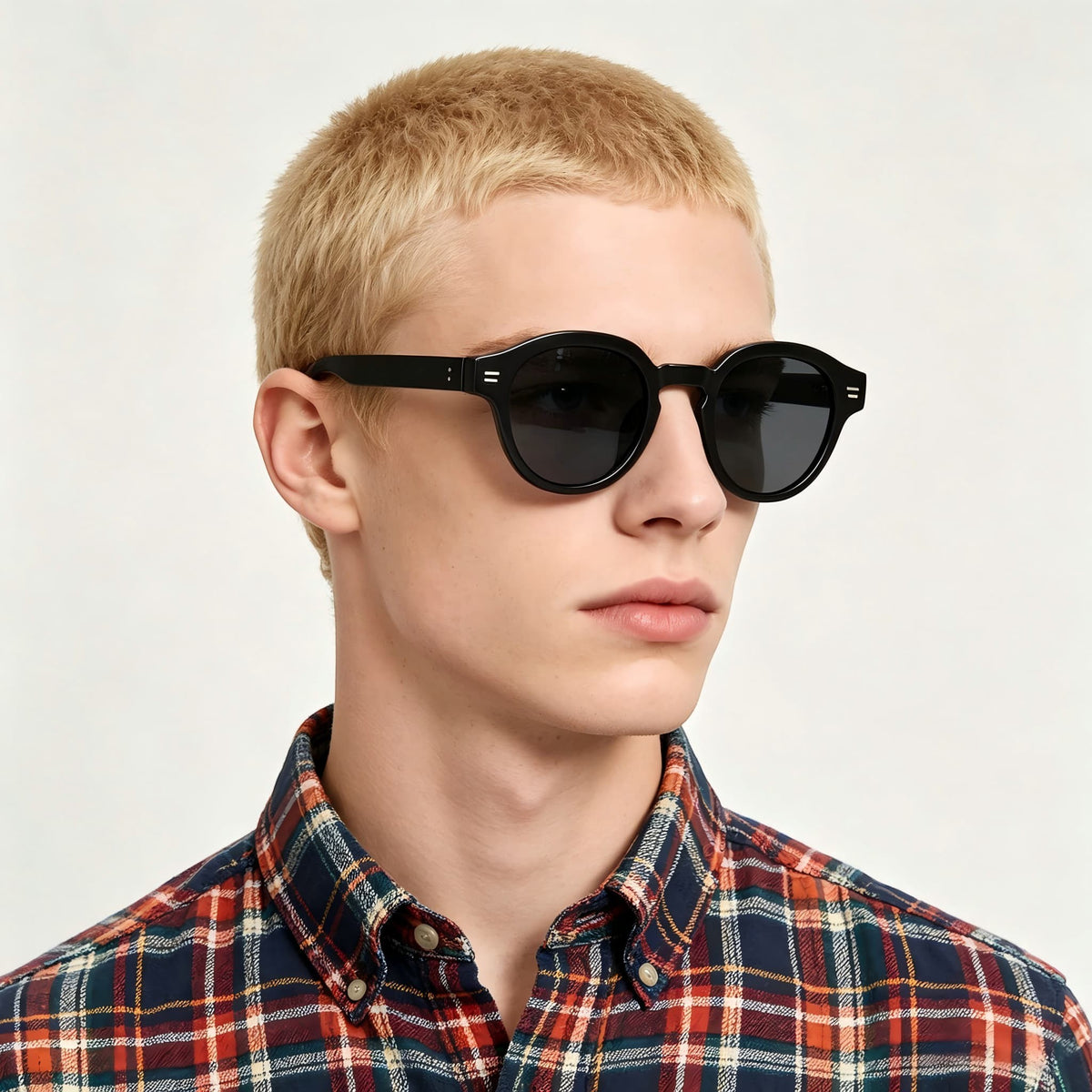 Blonde male model wearing AvilaDubee TZ5108 black retro round polarized TR90 sunglasses, casual plaid shirt street fashion lifestyle shot for everyday driving and festival outfits
