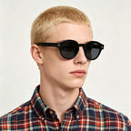 Blonde male model wearing AvilaDubee TZ5108 black retro round polarized TR90 sunglasses, casual plaid shirt street fashion lifestyle shot for everyday driving and festival outfits