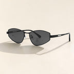 Soft shadow studio shot of AvilaDubee futuristic slim angular sunglasses, matte black lightweight metal frame dark grey UV protection lenses trendy Y2K streetwear eyewear for men women