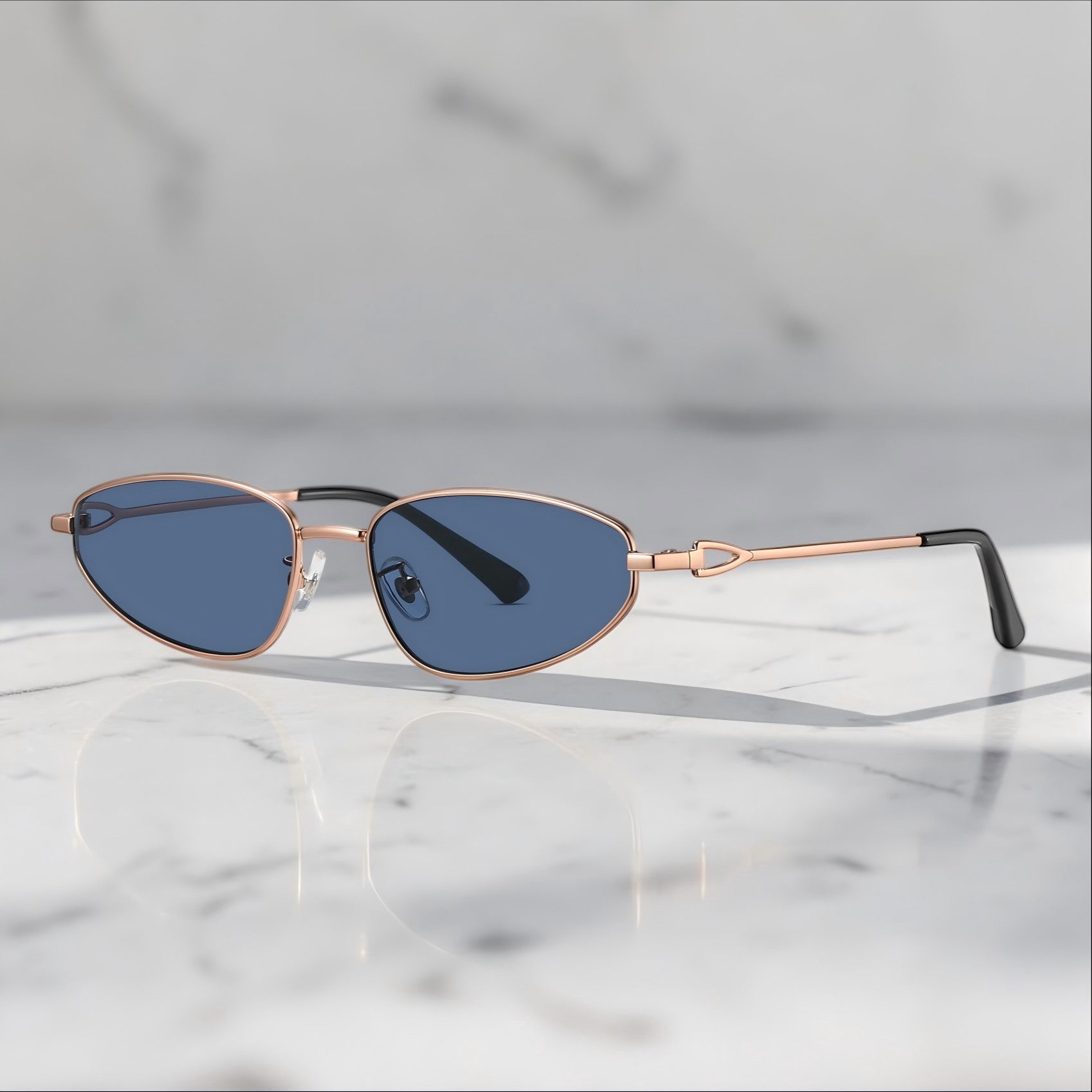 Soft marble reflection studio shot of AvilaDubee unisex vintage small-fit oval sunglasses, gold high-nickel copper alloy frame blue UV-block nylon lenses sleek retro street fashion shades
