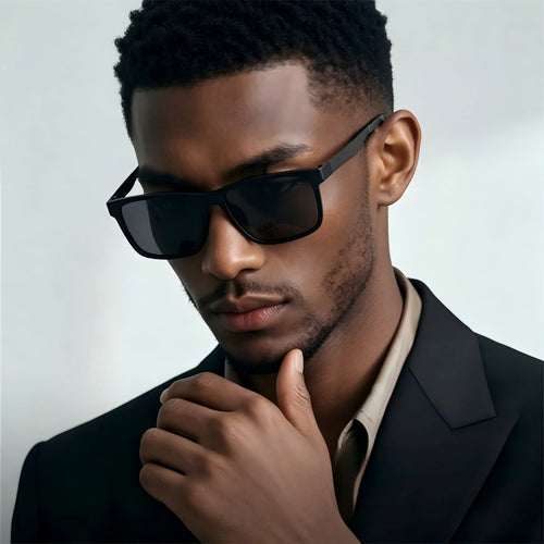 Black male model wearing AvilaDubee YJ6660 matte black square titanium sunglasses with formal suit, business office lifestyle shot ideal for daily driving and corporate occasions