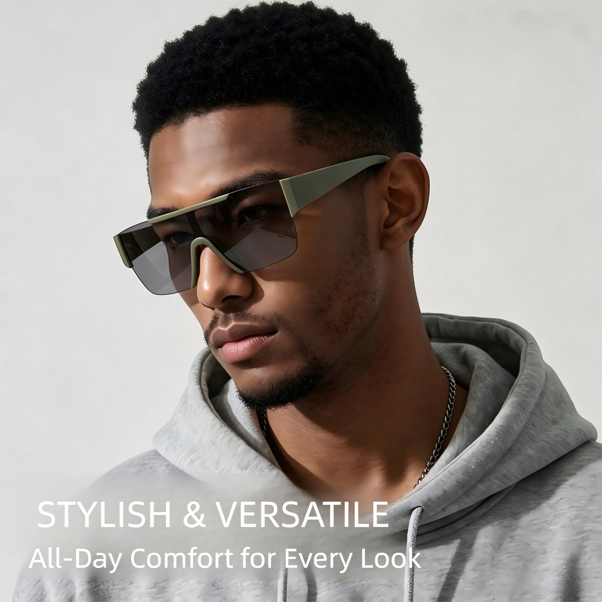 Black male model wearing AvileDubee HB80385 matte green shield sunglasses with grey hoodie, stylish street fashion lifestyle shot, all-day lightweight comfortable fit for outdoor rides & festivals