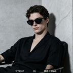 Male model wearing glossy black retro cat eye polarized sunglasses, minimalist marble wall background street style eyewear